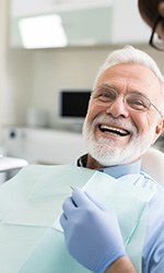 Older man smiling at dentist’s office
