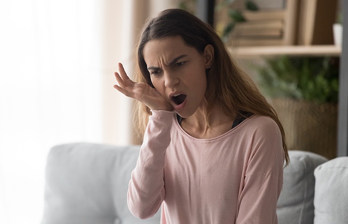 Patient in Studio City holding their cheek needing a root canal treatment