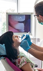  Patient in Studio City talking to dentist about a root canal treatment